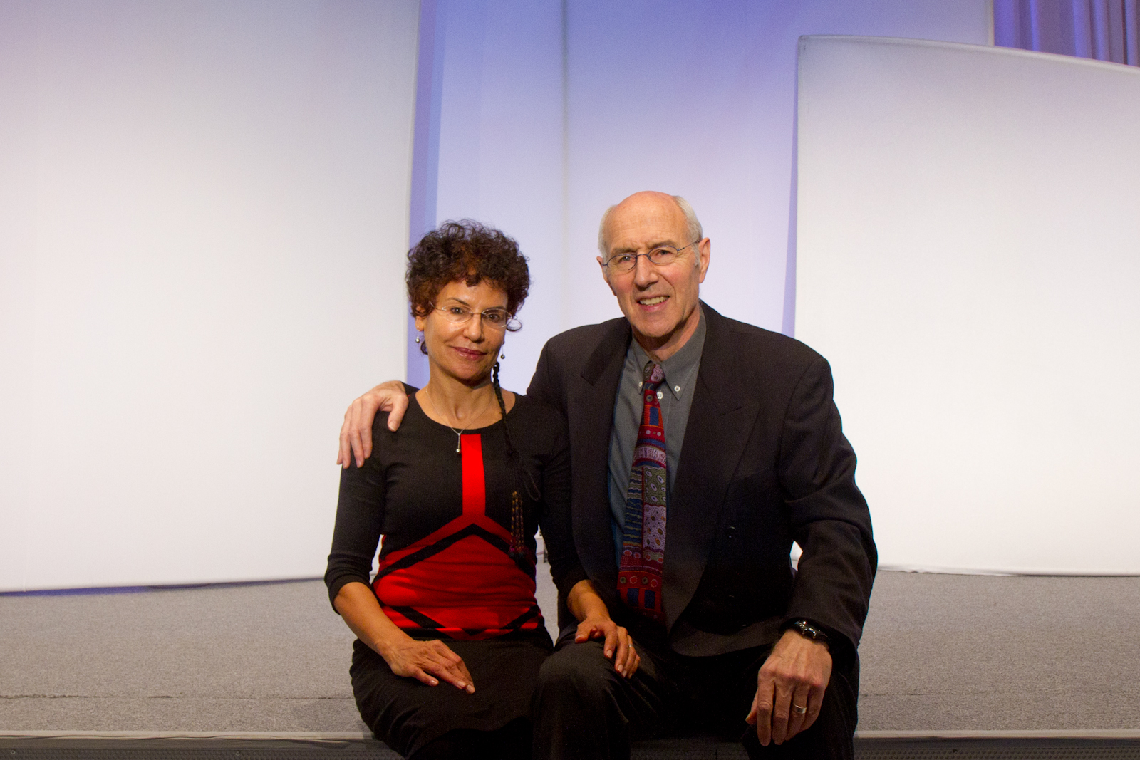 two people sitting on a stage