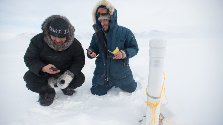 Scientists taking ice sample