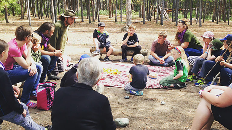 Children and adults in forest camp