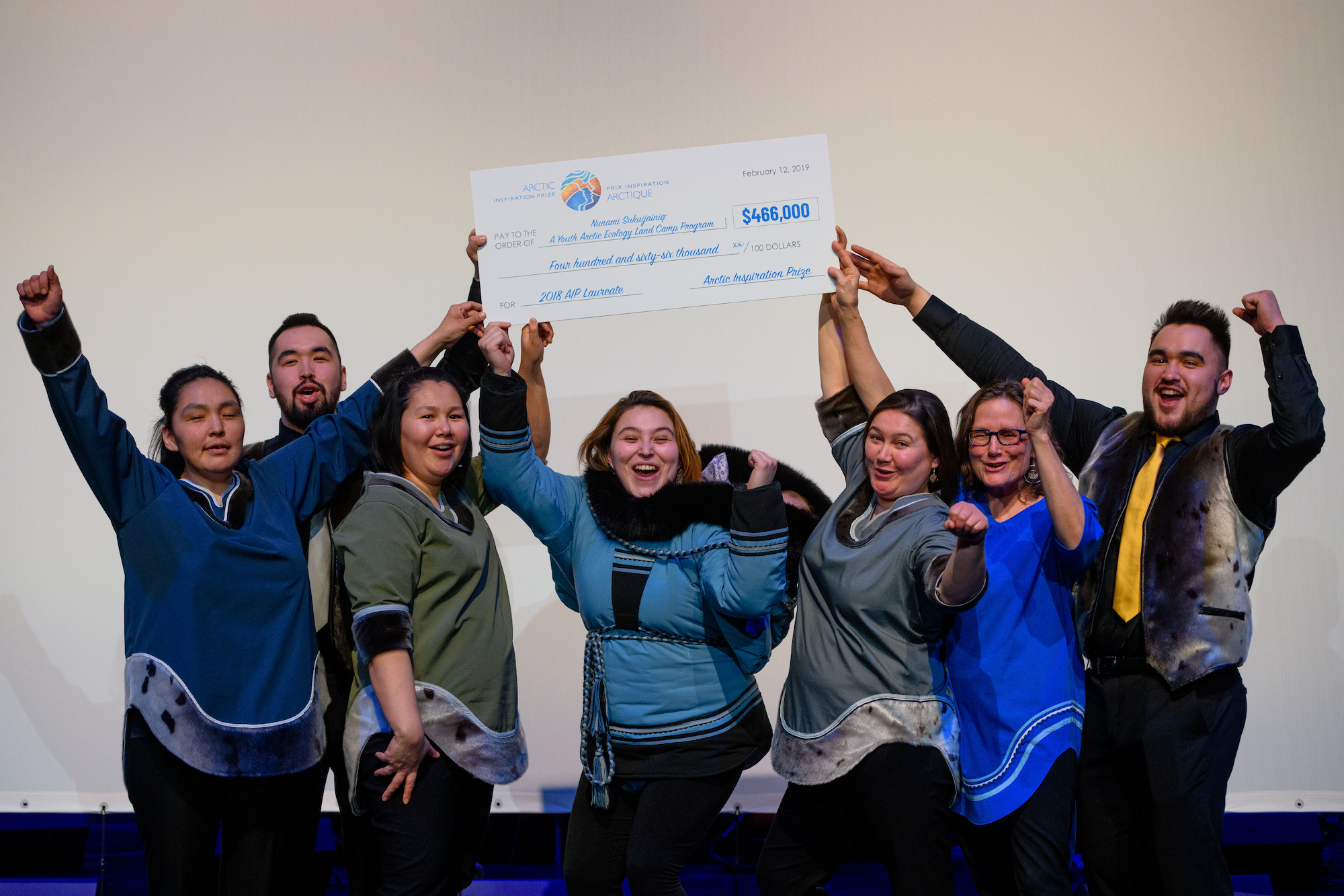 people cheering with a big cheque