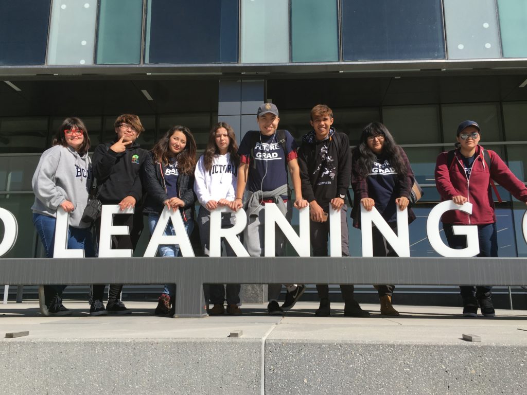 youth in front of learning sign